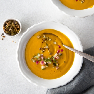 Bowl of Vegan Cumin-Carrot Soup shot from above with a spoon