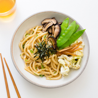 yaki udon bowl with snap peas, mushrooms, carrots and noodles