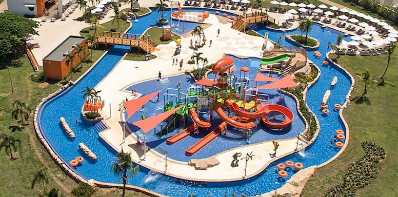 Aerial view of the Aqua Nick water park at Punta Cana Nickelodeon Resort featuring colorful slides, swimming pools, and a lazy river