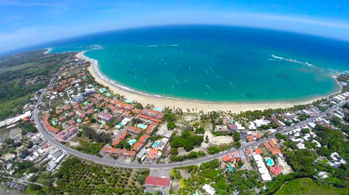 Panoramic aerial view of a tropical beach resort town and turquoise ocean
