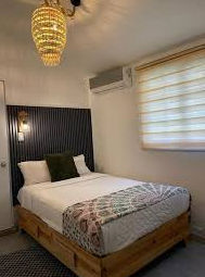 Rooftop terrace at S27 Backpackers hostel in Santo Domingo with wicker chairs and panoramic city views