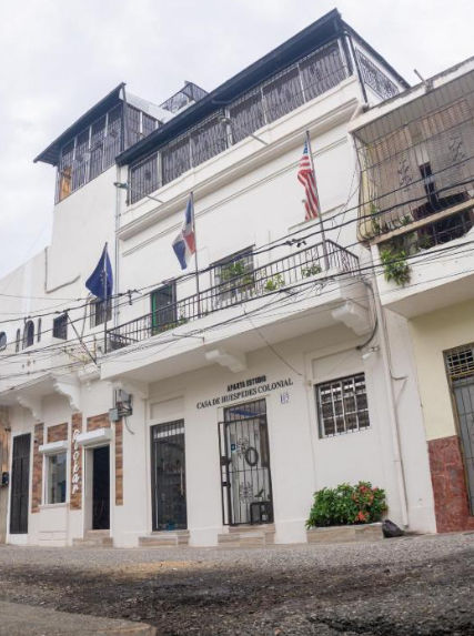 Exterior facade of Casa de Huespedes Colonial showing the CHC sign and address number 103