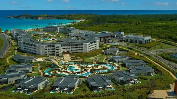 Aerial view of a large beachfront resort complex with swimming pools