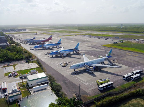 Aerial view of commercial airplanes parked at airport terminal gates