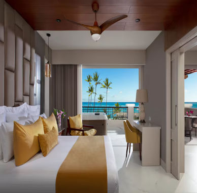 Luxury resort suite bedroom with ocean view and balcony hot tub