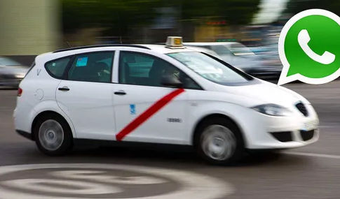 Fast moving white taxi with a green WhatsApp icon