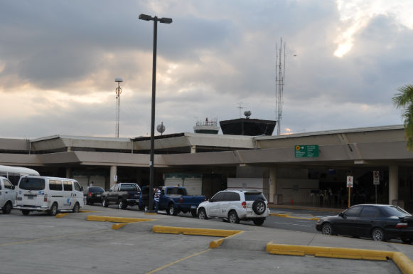 Exterior view of Puerto Plata Airport terminal with transfer vehicles waiting