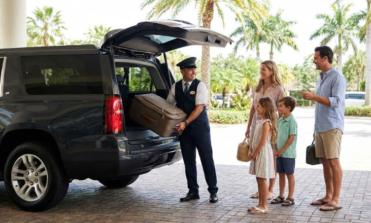 Private transportation driver assisting family with luggage at Moon Palace The Grand Cancun