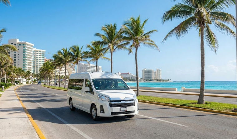 Private shuttle van transferring from Cancun Airport to the Hotel Zone, driving along the coast.