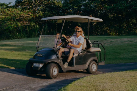 Man driving a golf cart on a course in La Romana, Dominican Republic