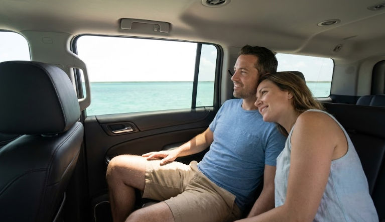Relaxed couple in private Suburban transportation towards Hotel Paradisus Cancun