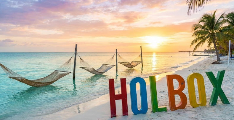 Iconic Holbox sunset with water hammocks and colorful sign - Destination for safe Cancun to Holbox shuttle 2026