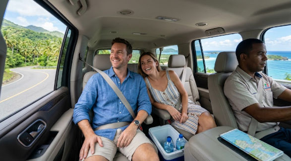 Happy couple safely exploring a tropical coastal road in a comfortable private transfer with a professional driver