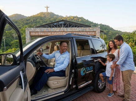 A Taxi Dominicana driver welcomes a family to the Puerto Plata Cable Car base station, with the statue of Christ visible in the background.