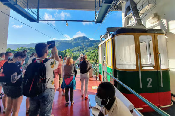 Tourists waiting at the Puerto Plata cable car station with Mount Isabel de Torres in the background
