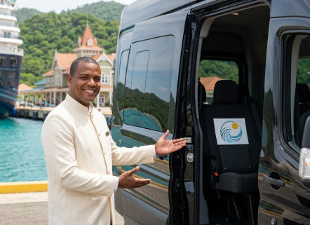 Smiling private driver welcoming passengers into a luxury transport van at Amber Cove cruise port
