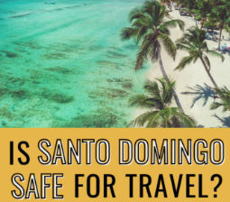 Aerial view of a tropical beach with palm trees and text asking Is Santo Domingo safe for travel