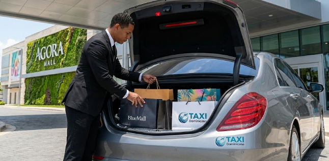 Chauffeur loading shopping bags from BlueMall and TAXI Dominicana into a car trunk outside Agora Mall in Santo Domingo