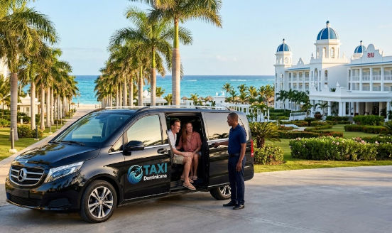 Black luxury Taxi Dominicana van with a driver assisting a couple arriving at Riu Palace Macao resort