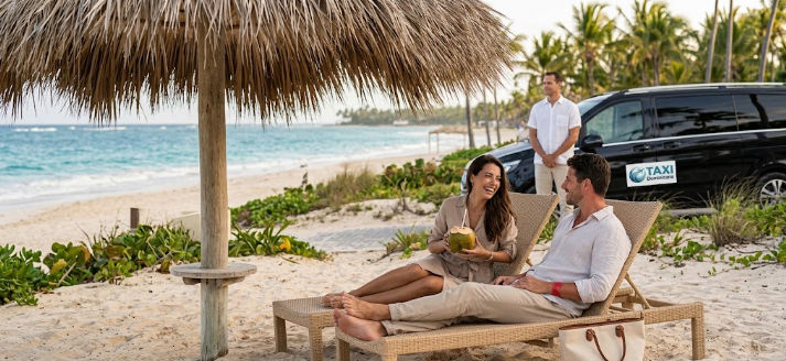 Couple relaxing on sun loungers at a tropical beach with a private driver vehicle nearby
