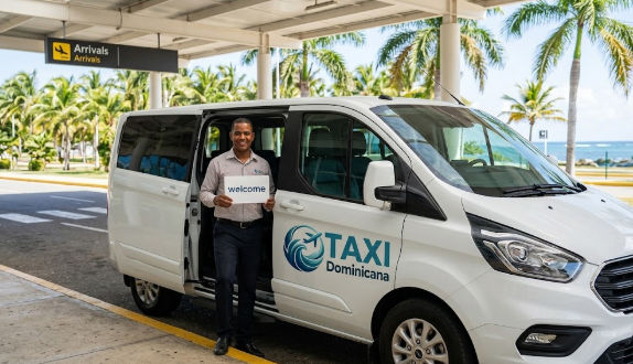 Professional Taxi Dominicana driver with a welcome sign standing by a white minivan at an airport arrivals terminal.