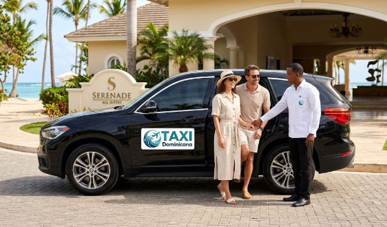 A couple arriving at the Serenade All Suites hotel in a black Taxi Dominicana SUV transfer