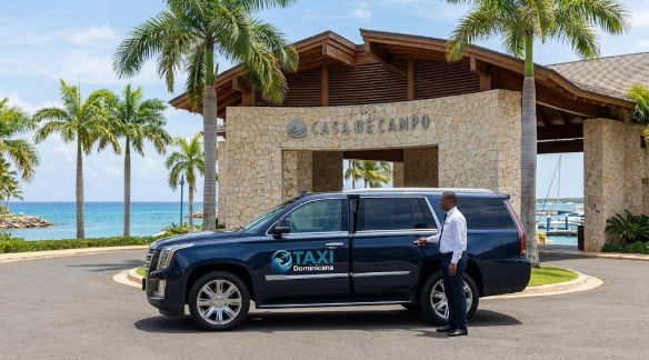 Luxury Taxi Dominicana SUV with a chauffeur opening the door at Casa de Campo resort entrance
