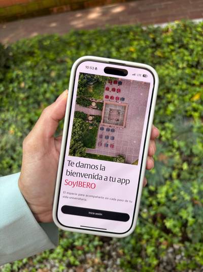 Smartphone displaying a minimalist app interface with aerial imagery, clean typography, and login button.