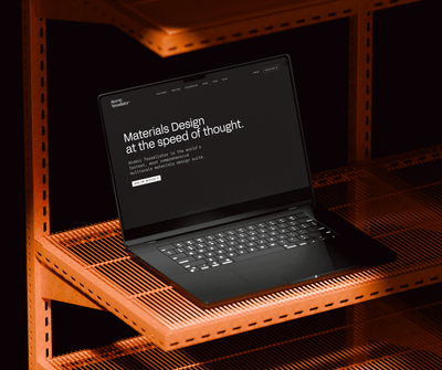 Professional dark-themed UI on a laptop screen atop vibrant orange industrial metal shelving.
