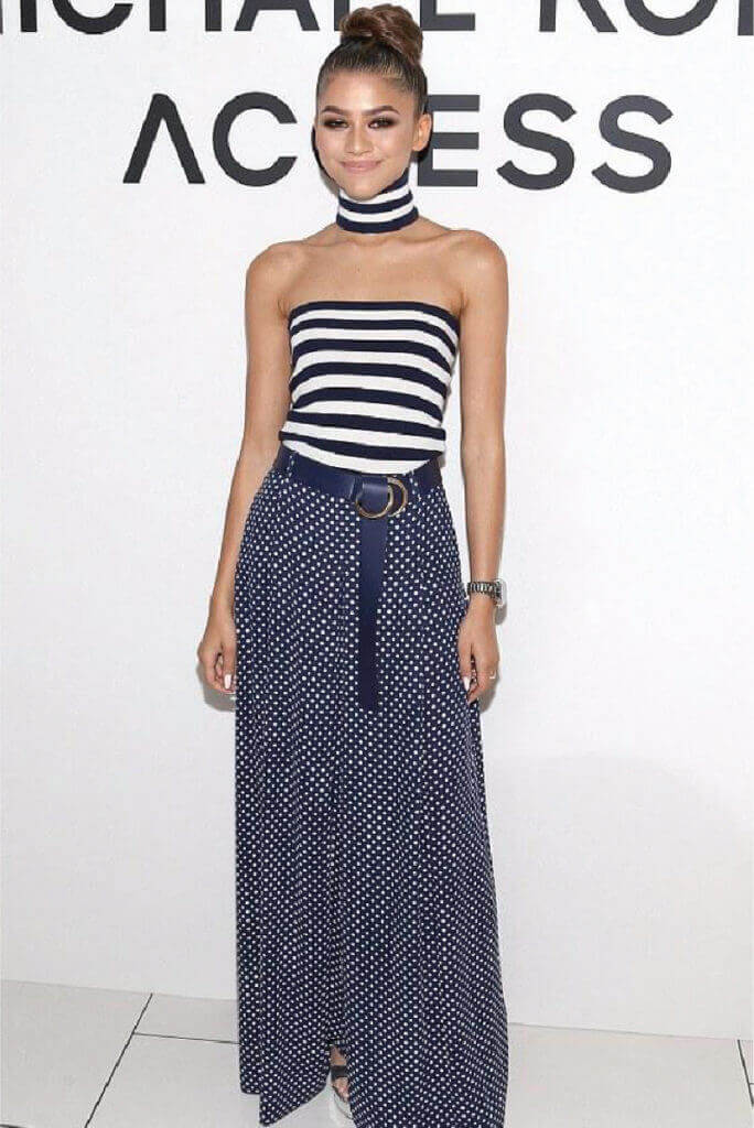 Zendaya in a chic navy and white, tube top and choker necklace look