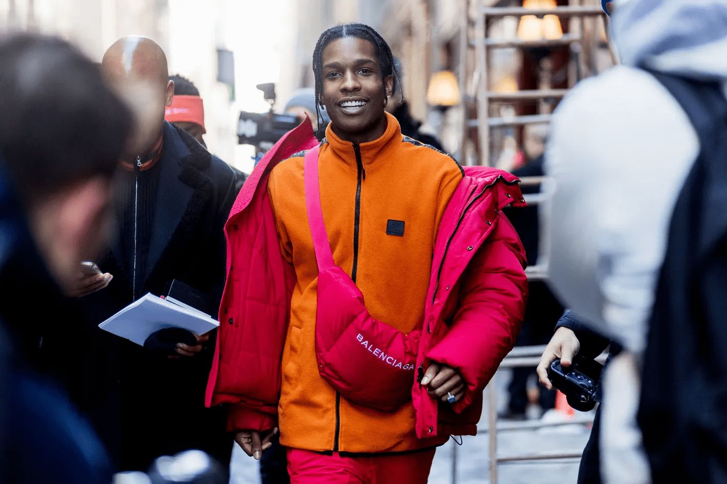 ASAP Rocky in an orange jacket and red pants showcasing Gorpcore Fashion in style
