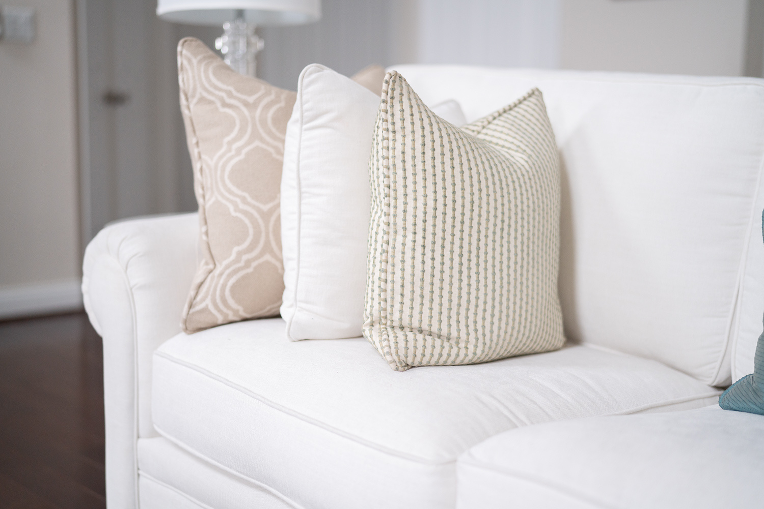 Neutral-themed pillowcases made from decorative rugs on a white sofa