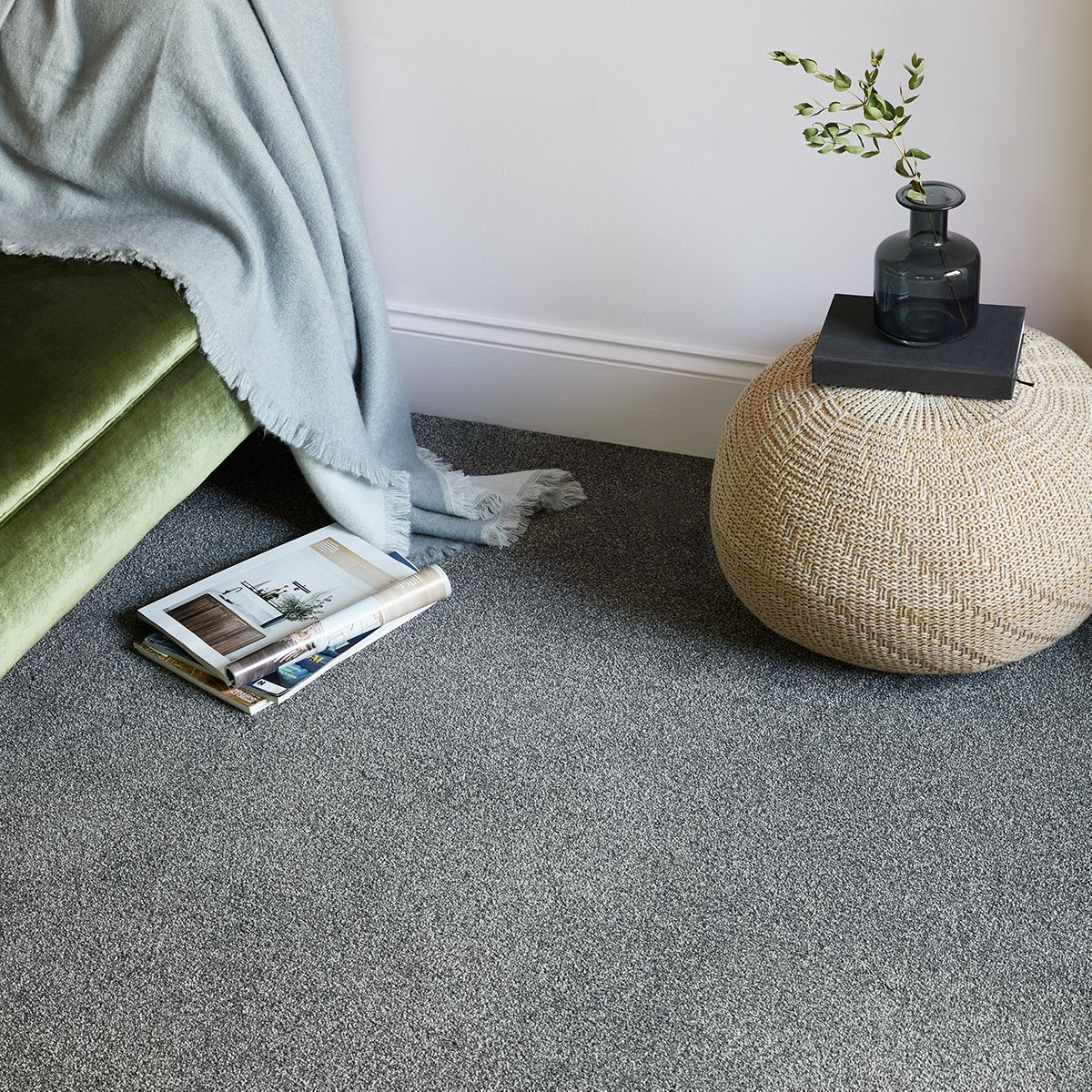 Bedroom vignette showing velvet green upholstery, baby blue tapestry and gray carpet﻿