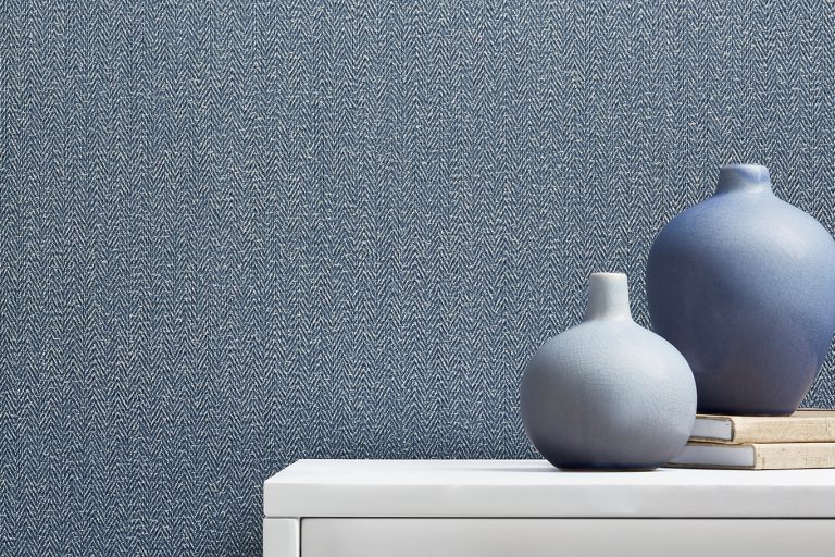 Gray textured wallpaper as backdrop for vases display﻿﻿