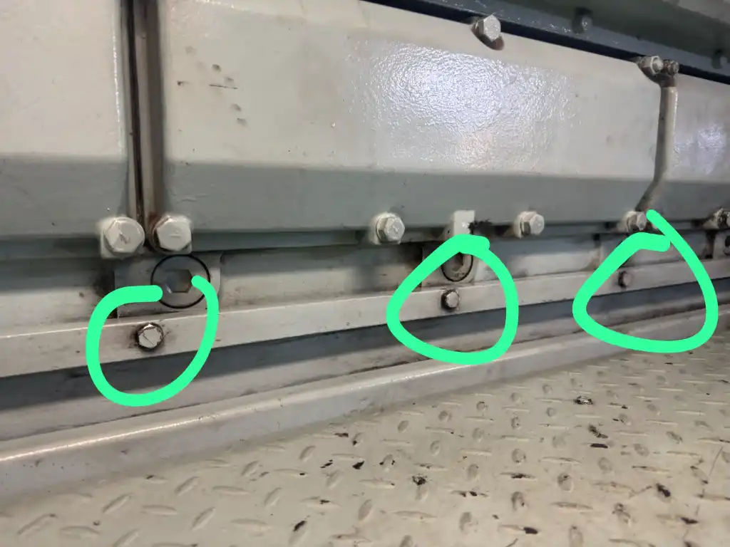 Auxiliary Engine: Oil leaking out of drain line under camcase. The marked banjo bolts are connected to the