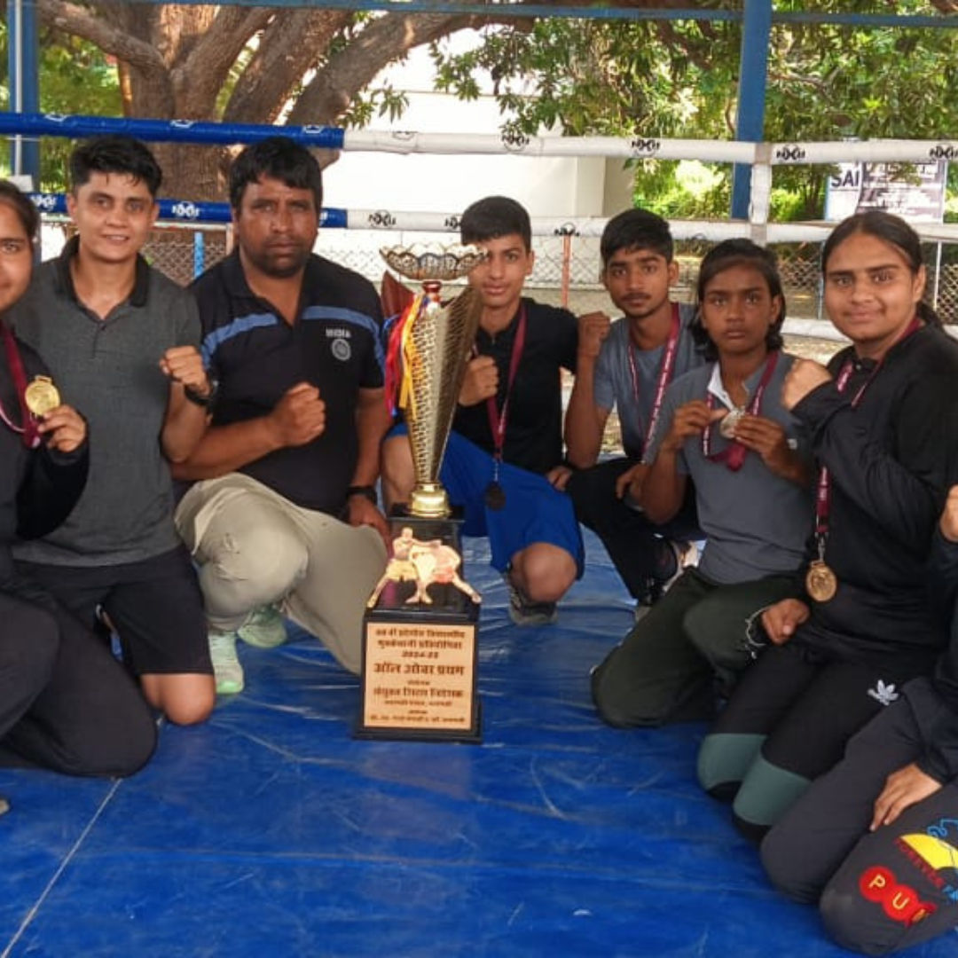 A coach giving instructions to a young boxer.