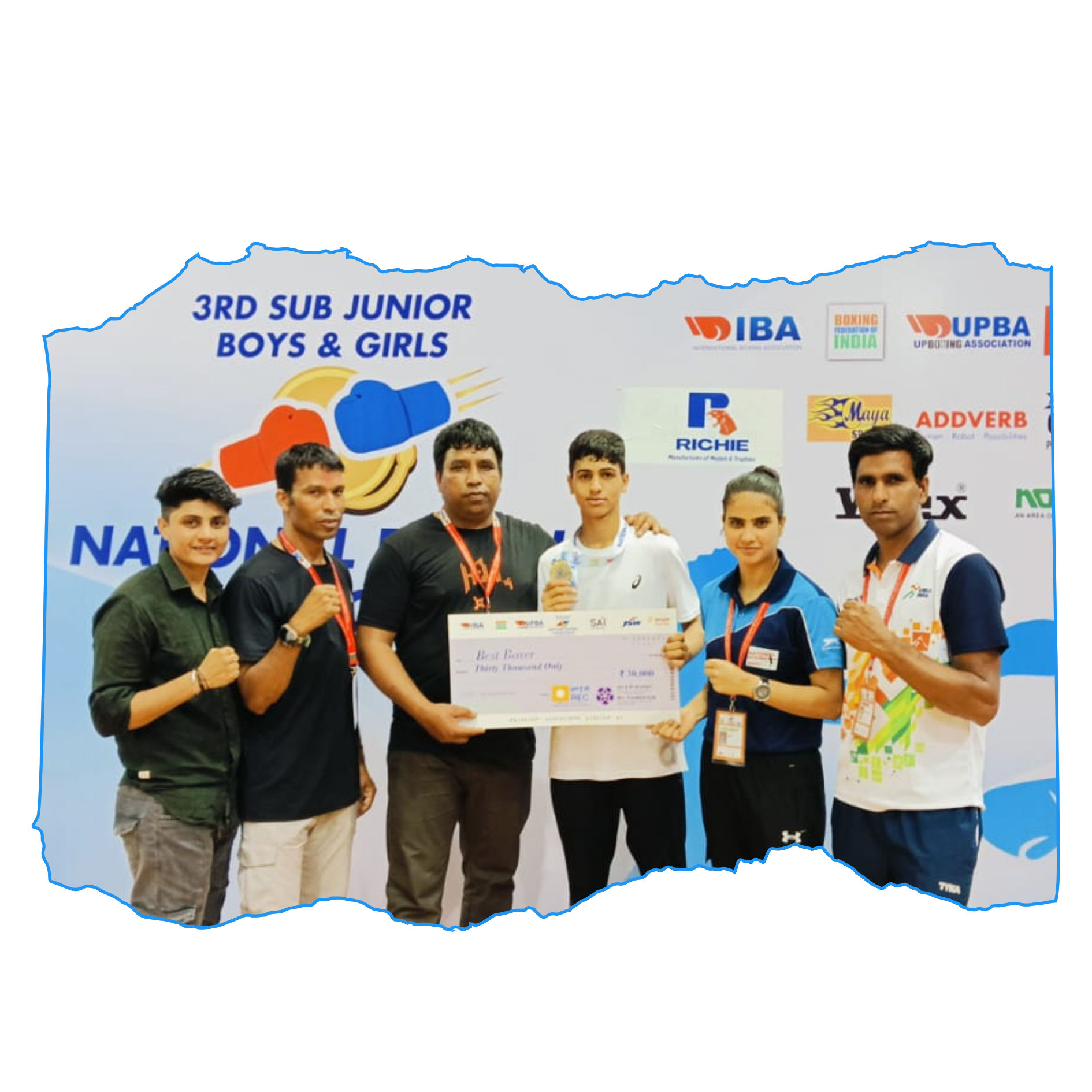 A female boxer posing in the ring.