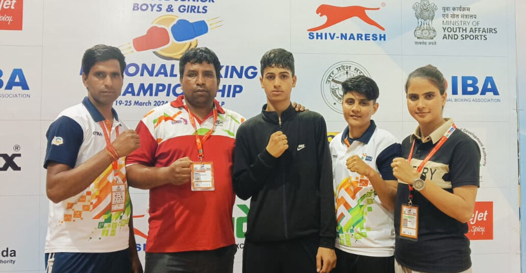Coaches and young boxers posing together at a national championship event.