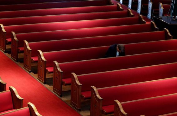 A man prays at Trinity Baptist Church in San Antonio, TX. The Associated Press