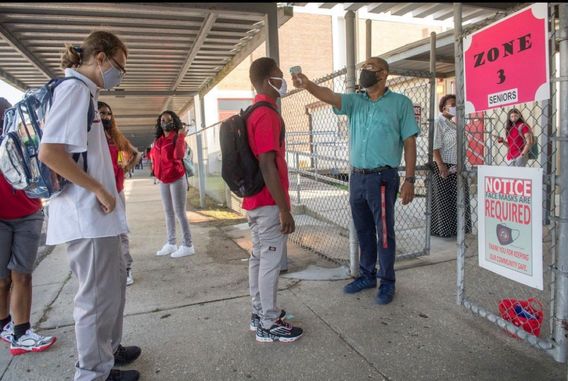 High school students getting their temperature checked before entering their school in Harvey, La., on Monday.