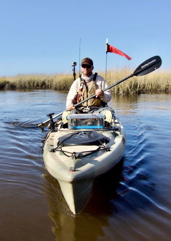 Mike paddles in a creek.