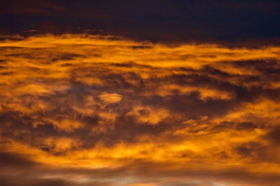 This a telephoto shot of the clouds in the photo above. Sunrise colors!