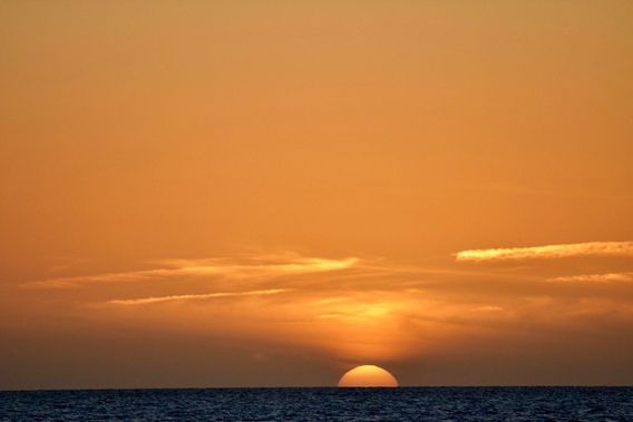 The sun sinks into the Gulf of Mexico.