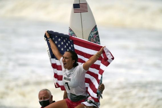 5x World Champ and first ever surfing Olympic Gold Medalist gets chaired up the beach after her feat in Japan.