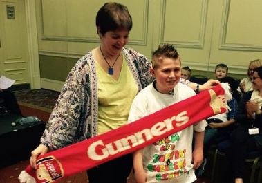 Koulla Holding a Arsenal Football Scarf