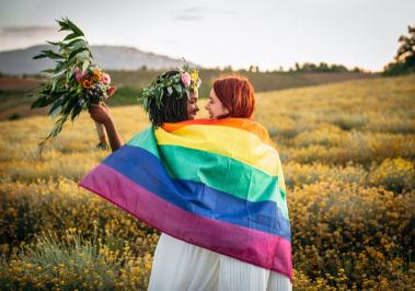 Image of Couple Cover in Gay Pride Flag