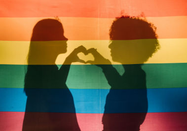 Marriage Equality: A Child’s Rights Issue - Cover Couple Behind Gay Pride Flag