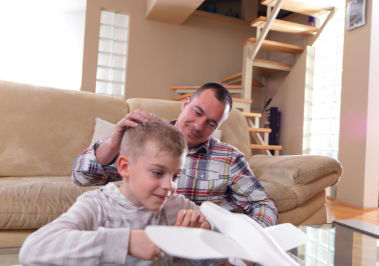 Father with Son looking at Toy Airplane