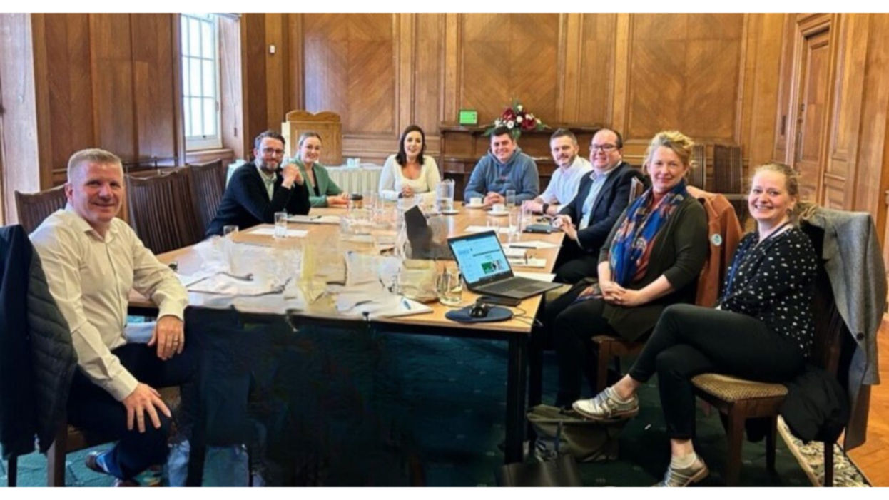 Group of people sitting round a table.