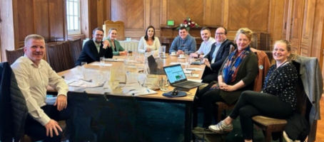 Group of people sitting round a table.